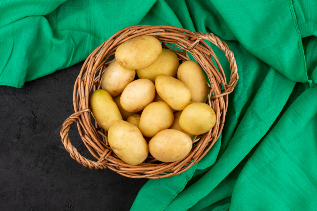 top view potatoes peeled out whole inside basket grey floor copie top view potatoes peeled out whole inside basket grey floor copie